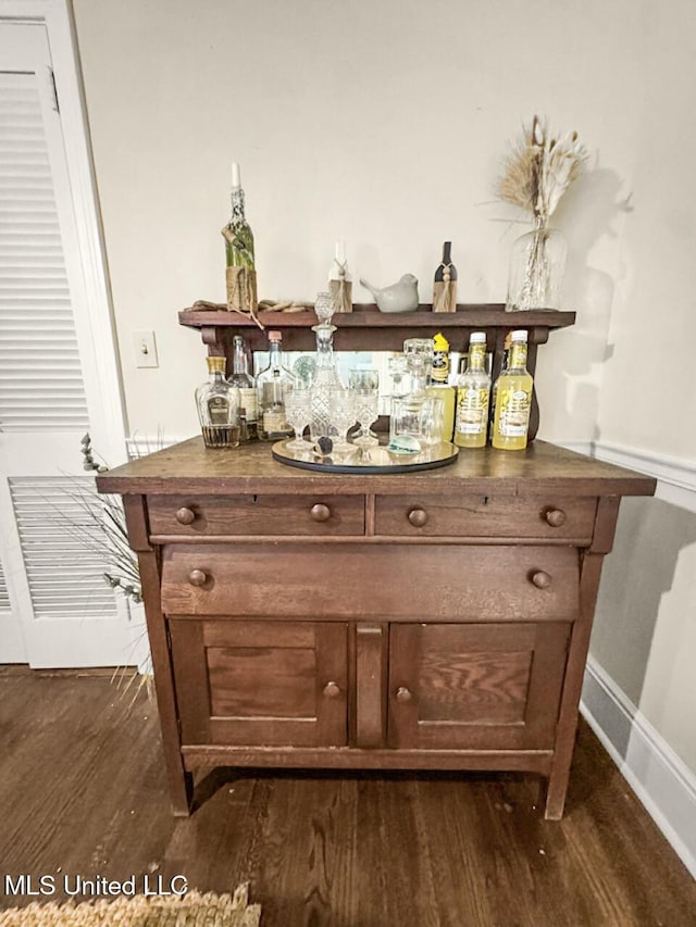 1802 Robinson St, Natchez, MS 39120 - bar featuring baseboards, a bar, and dark wood-style floors