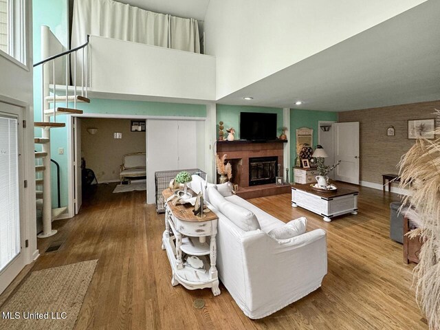 1802 Robinson St, Natchez, MS 39120 - living room featuring a towering ceiling, wood finished floors, stairs, and a fireplace