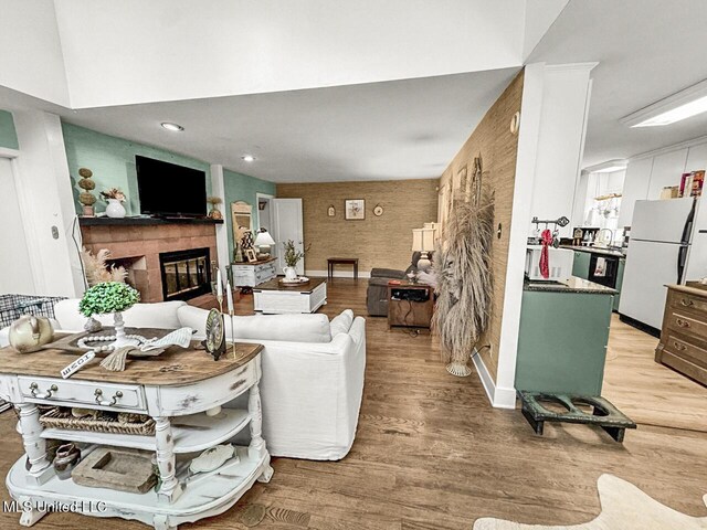 1802 Robinson St, Natchez, MS 39120 - living area featuring a tile fireplace and light wood-style floors