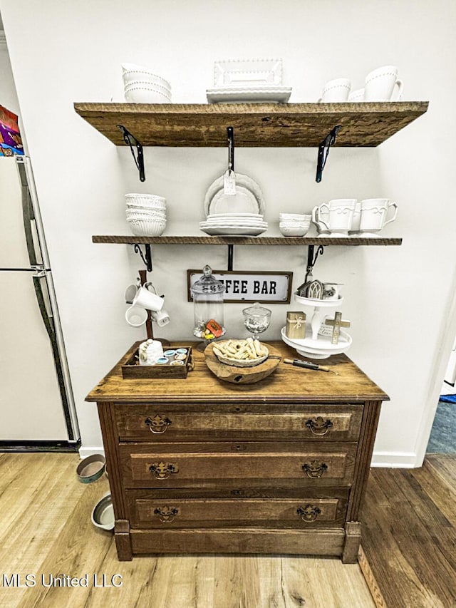 1802 Robinson St, Natchez, MS 39120 - bar featuring baseboards, light wood-type flooring, and freestanding refrigerator