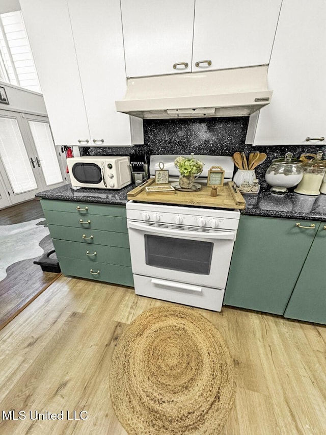 1802 Robinson St, Natchez, MS 39120 - kitchen featuring under cabinet range hood, white appliances, dark countertops, and green cabinetry