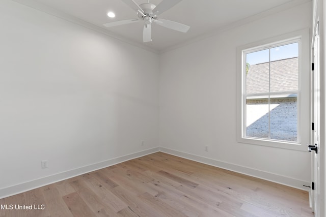 empty room featuring light hardwood / wood-style floors, ornamental molding, and ceiling fan