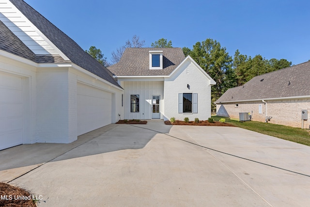 view of front facade with central AC unit and a garage