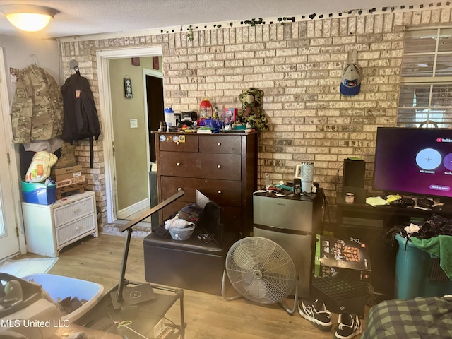 900 Orange St, Ocean Springs, MS 39564 - bedroom with wood finished floors and brick wall
