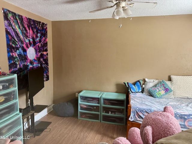 900 Orange St, Ocean Springs, MS 39564 - bedroom featuring a textured ceiling, wood finished floors, and ceiling fan
