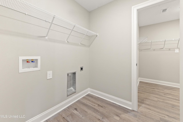 laundry room with baseboards, hookup for a washing machine, wood finished floors, and electric dryer hookup