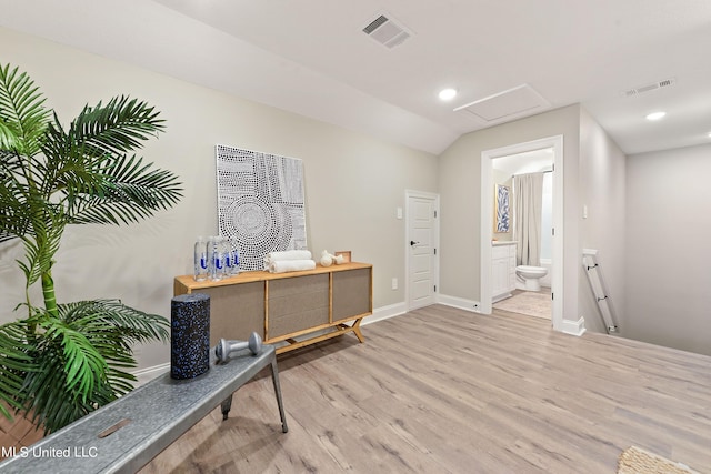 interior space with an upstairs landing, wood finished floors, attic access, baseboards, and recessed lighting
