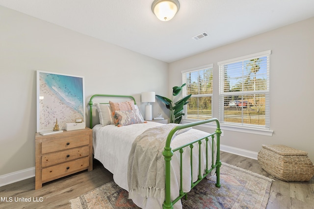 bedroom featuring wood finished floors and baseboards
