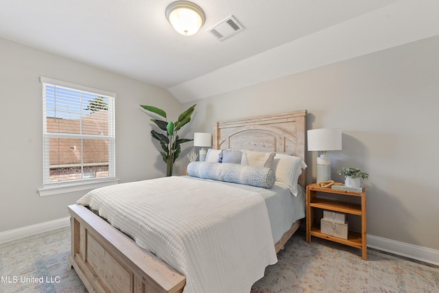 bedroom featuring baseboards and vaulted ceiling
