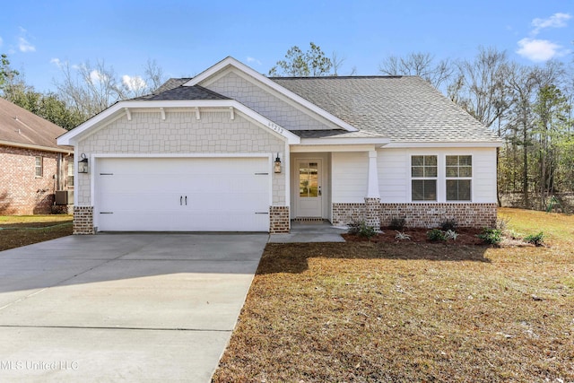 craftsman inspired home featuring brick siding, an attached garage, concrete driveway, and roof with shingles