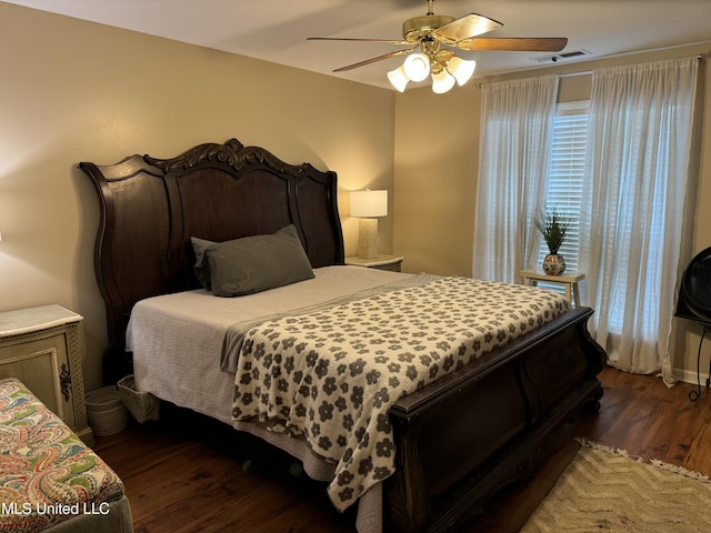 bedroom featuring dark hardwood / wood-style floors and ceiling fan