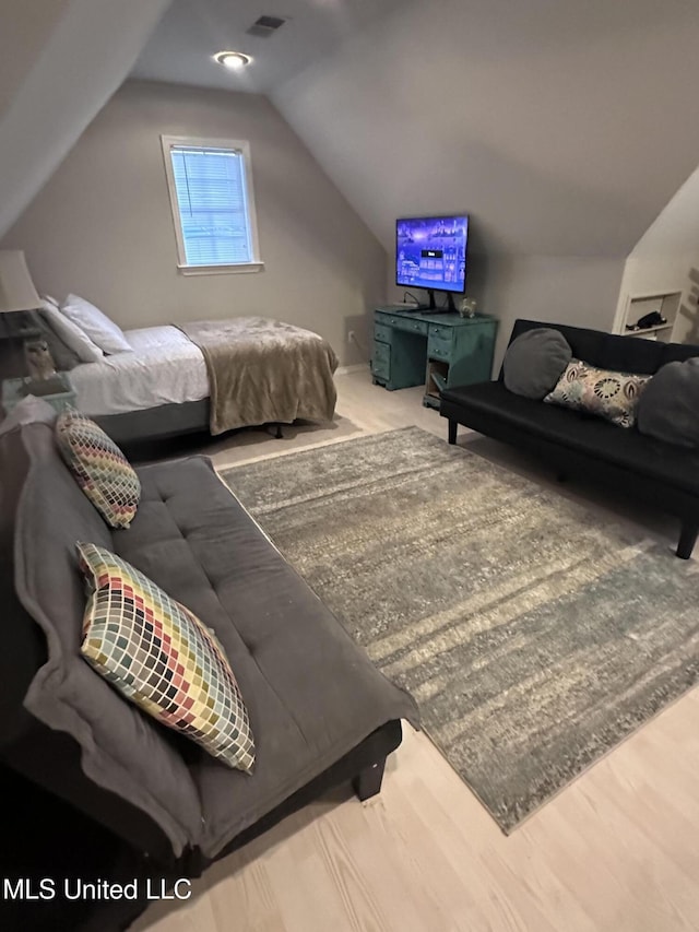 living room with wood-type flooring and vaulted ceiling