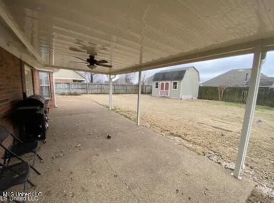 view of patio / terrace featuring a mountain view and a storage shed