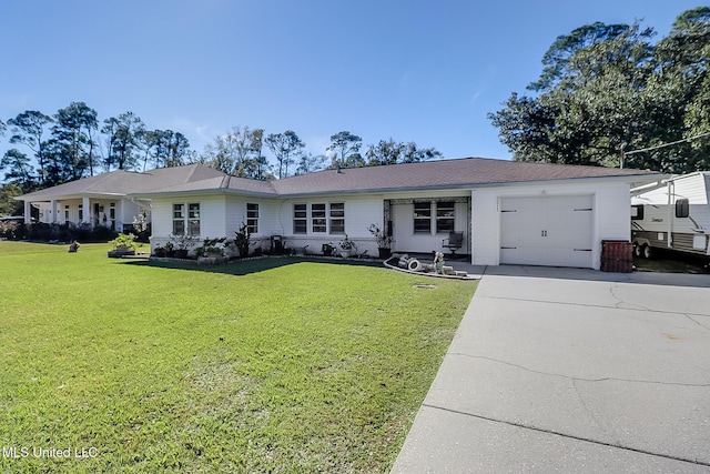 view of front of home with a garage and a front lawn