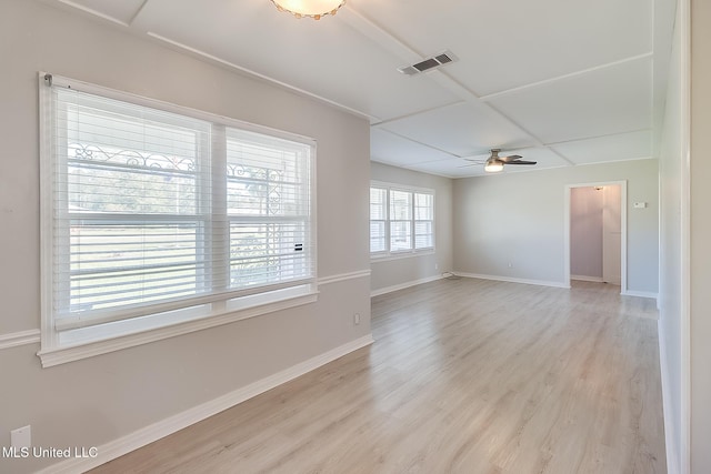 empty room with ceiling fan and light hardwood / wood-style flooring