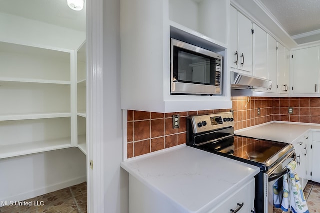 kitchen featuring white cabinets, decorative backsplash, ornamental molding, and appliances with stainless steel finishes