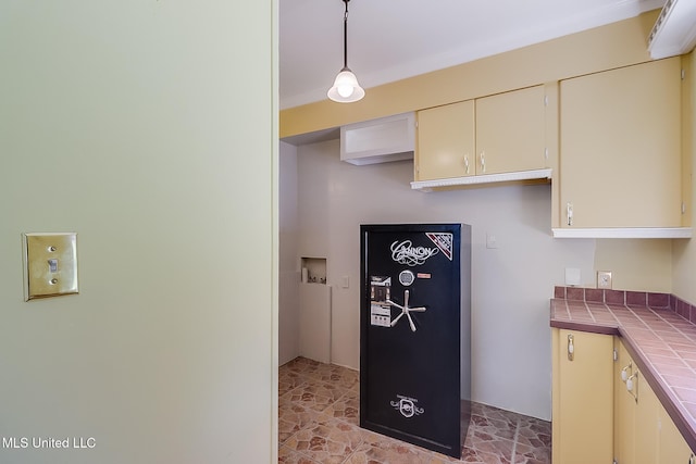 kitchen with pendant lighting and tile counters