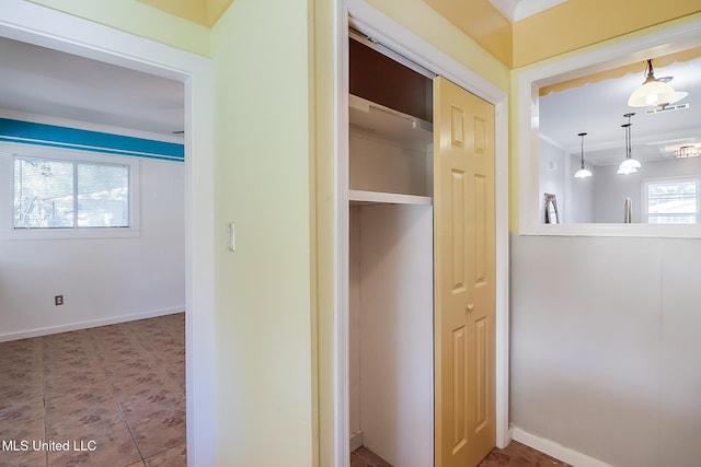 corridor featuring ornamental molding