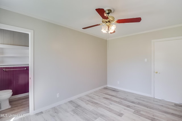 spare room with ceiling fan, ornamental molding, and light wood-type flooring