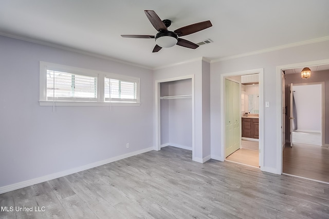 unfurnished bedroom with light wood-type flooring, ensuite bathroom, ceiling fan, crown molding, and a closet