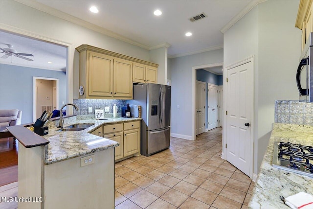 kitchen featuring kitchen peninsula, backsplash, ornamental molding, sink, and appliances with stainless steel finishes