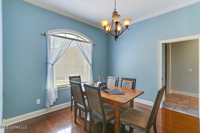 dining space featuring ornamental molding, a notable chandelier, and dark hardwood / wood-style floors