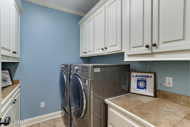 laundry area featuring cabinets, ornamental molding, washer and clothes dryer, and light tile patterned floors