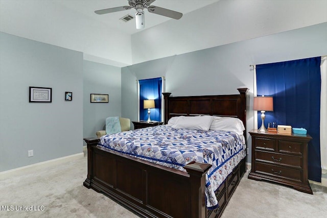 carpeted bedroom with ceiling fan and vaulted ceiling