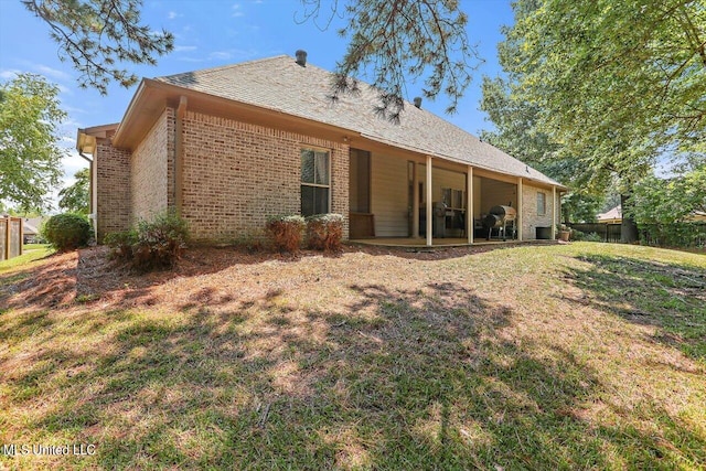 back of house featuring a yard