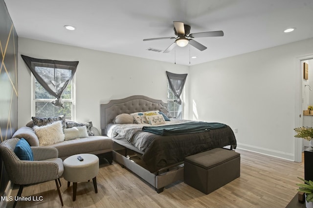 bedroom with light wood-style floors, recessed lighting, visible vents, and baseboards