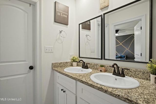 bathroom with a sink and double vanity
