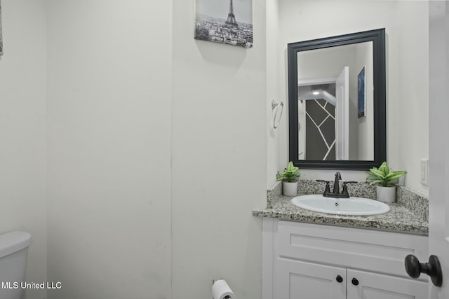 bathroom with toilet and vanity