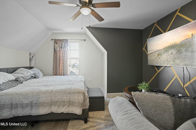 bedroom featuring vaulted ceiling, wood finished floors, and a ceiling fan