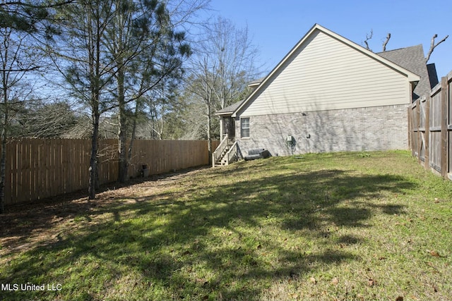 view of yard with a fenced backyard