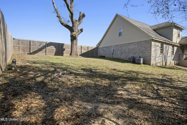 exterior space with central air condition unit and a fenced backyard