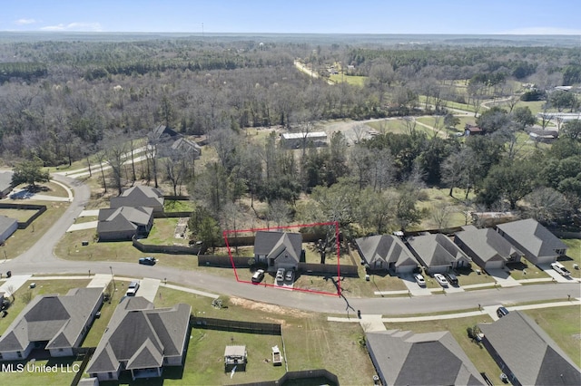 birds eye view of property with a residential view and a view of trees