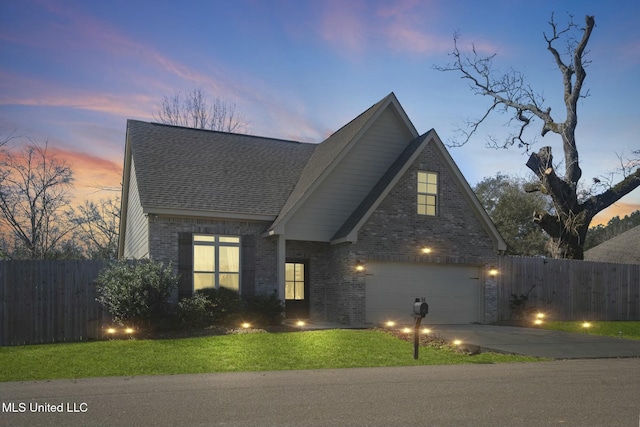 traditional-style house featuring a shingled roof, brick siding, fence, and driveway