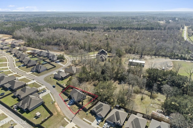 birds eye view of property with a residential view and a view of trees