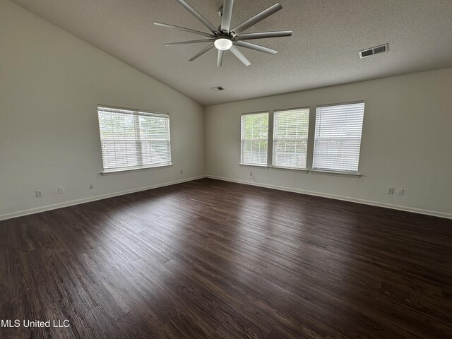 7413 Fox Creek Dr, Olive Branch, MS 38654 - spare room with a ceiling fan, a textured ceiling, visible vents, vaulted ceiling, and dark wood-style floors
