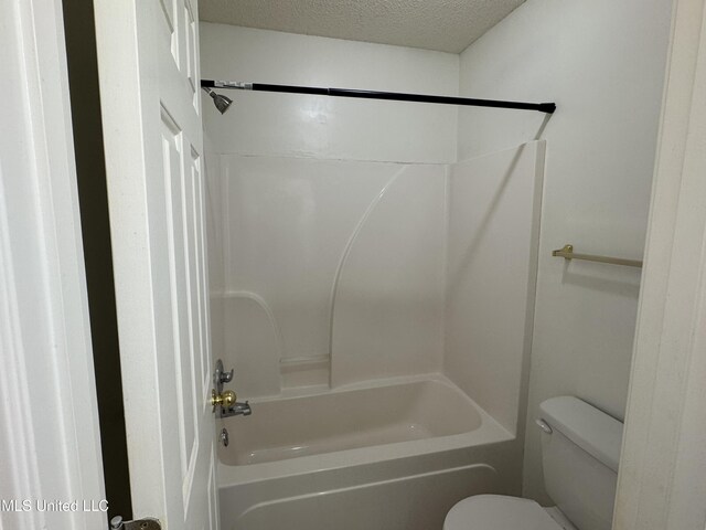 7413 Fox Creek Dr, Olive Branch, MS 38654 - bathroom with toilet, a textured ceiling, and bathing tub / shower combination