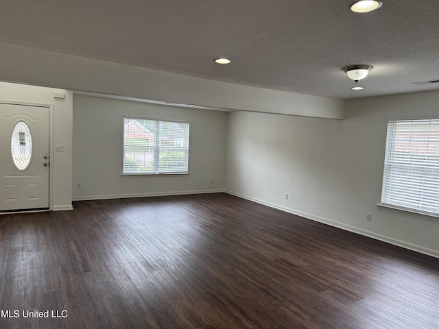 7413 Fox Creek Dr, Olive Branch, MS 38654 - foyer with a textured ceiling, visible vents, baseboards, dark wood-style floors, and recessed lighting