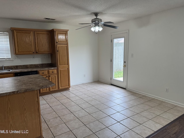 7413 Fox Creek Dr, Olive Branch, MS 38654 - kitchen featuring visible vents, dark countertops, ceiling fan, a textured ceiling, and a sink