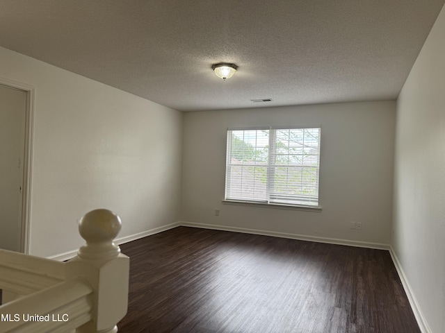 7413 Fox Creek Dr, Olive Branch, MS 38654 - unfurnished room featuring baseboards, dark wood finished floors, a textured ceiling, and visible vents
