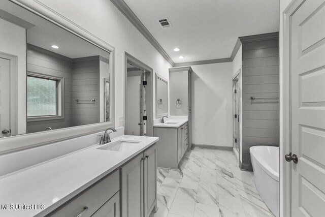 115 Grayson Way, Madison, MS 39110 - bathroom featuring ornamental molding, two vanities, marble finish flooring, a freestanding bath, and a stall shower