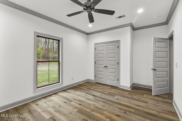 115 Grayson Way, Madison, MS 39110 - unfurnished bedroom featuring crown molding, hardwood / wood-style floors, baseboards, recessed lighting, and a closet