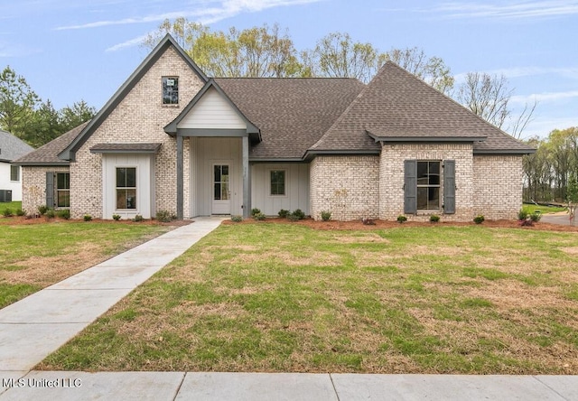 115 Grayson Way, Madison, MS 39110 - french country style house featuring a shingled roof, a front lawn, and brick siding