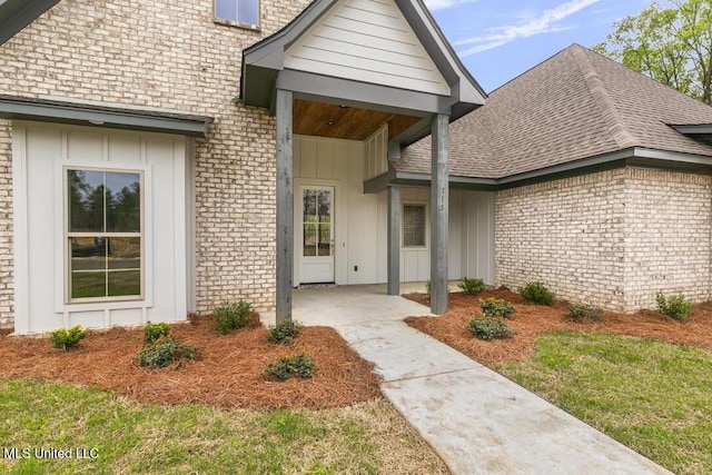 115 Grayson Way, Madison, MS 39110 - doorway to property with a shingled roof, board and batten siding, and brick siding