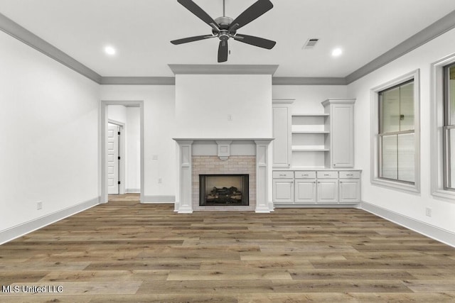 115 Grayson Way, Madison, MS 39110 - unfurnished living room featuring ornamental molding, wood finished floors, ceiling fan, a fireplace, and baseboards