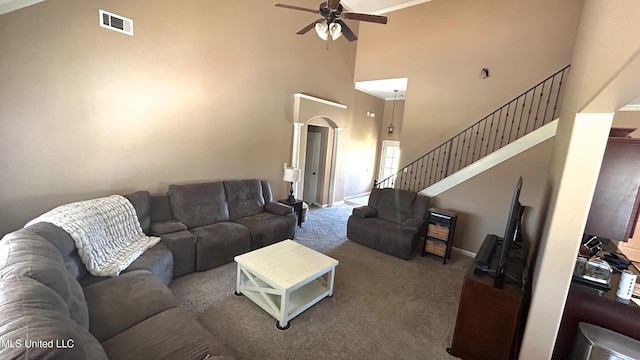 14291 Buttercup Dr, Olive Branch, MS 38654 - living area with a ceiling fan, a high ceiling, carpet, stairway, and arched walkways