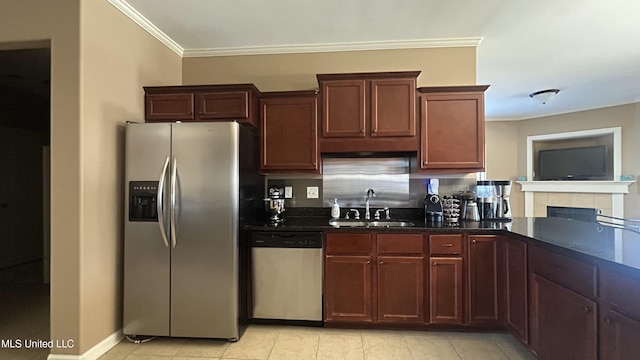 14291 Buttercup Dr, Olive Branch, MS 38654 - kitchen featuring stainless steel appliances, a sink, ornamental molding, light tile patterned floors, and dark stone counters